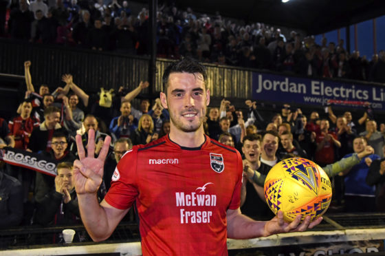 Ross County striker Brian Graham takes home the match ball.