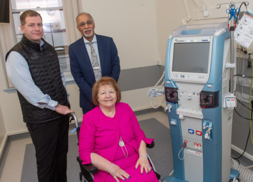 Simon Cowie with Dr Izhar Khan, NHS Grampian consultant nephrologist and Hiezel Cowie next to one of the new machines.