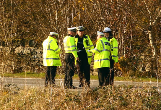Police officers at the scene of the crash.