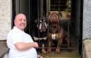 David Clark at his home with his dogs Butch and Bruno.