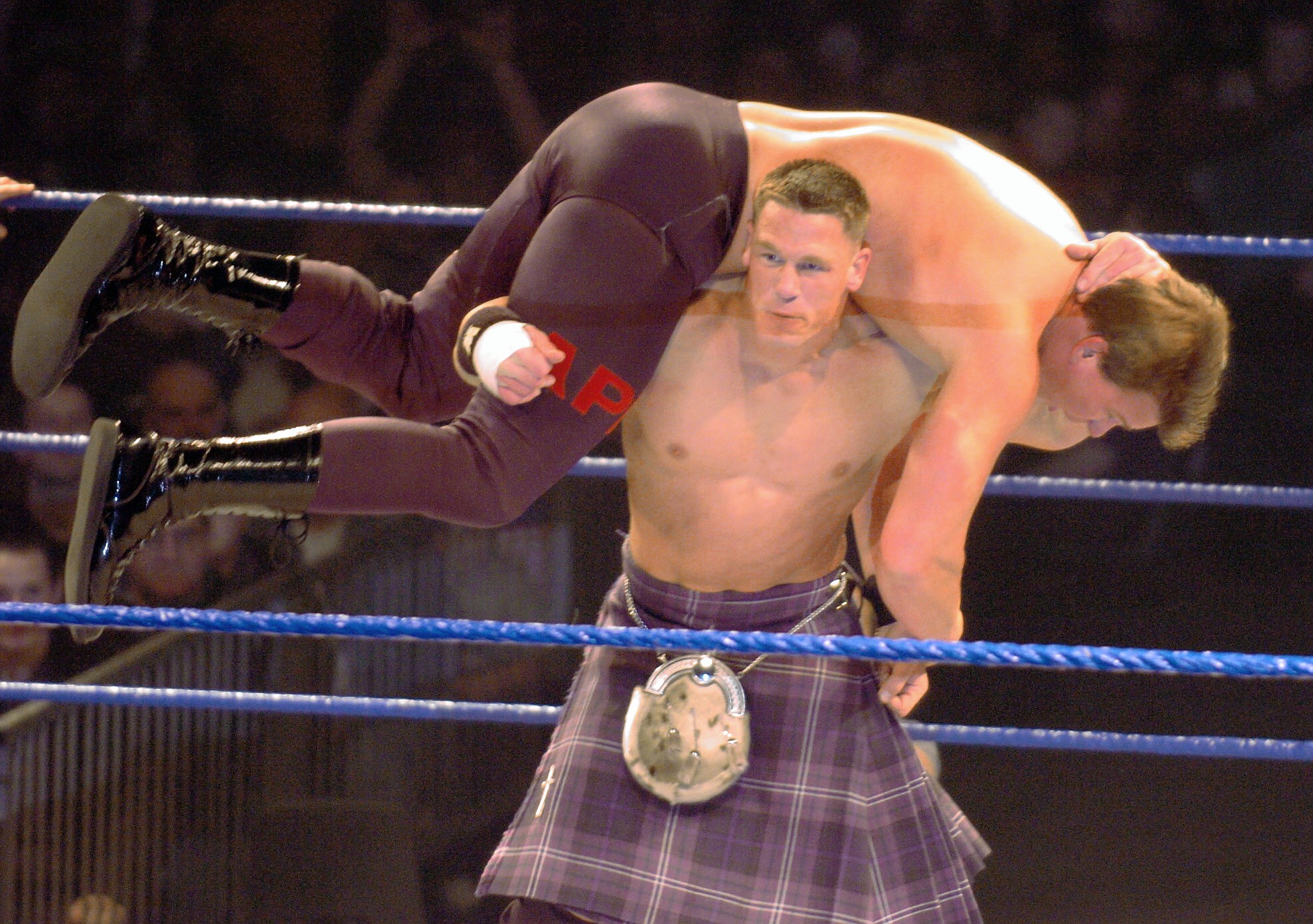 John Cena, wearing a kilt, lifts up Bradshaw in 2004