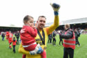 Dean Brill celebrates with his daughter Rosie as Leyton Orient win the Vanarama National League title.