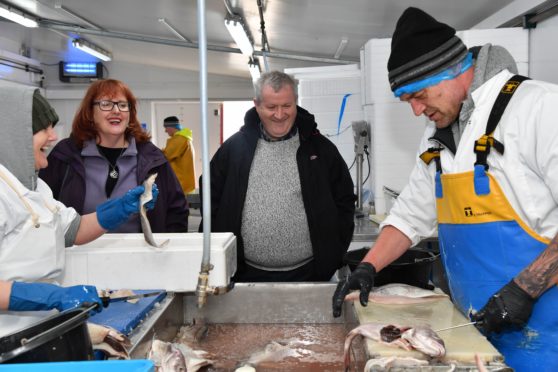 SNP WESTMINSTER LEADER IAN BLACKFORD MP AND MP DEIDRE BROCK WATCHING FILLETERS AT WORK IN KINNAIRD SEAFOODS.