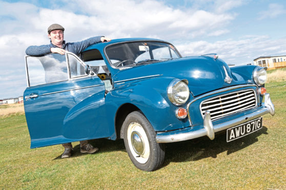 Darren Macrae from Embo with his 1969 Morris Minor 1000 in Trafalgar Blue photographed at Dornoch.