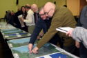 Residents assess the flood prevention plans in January