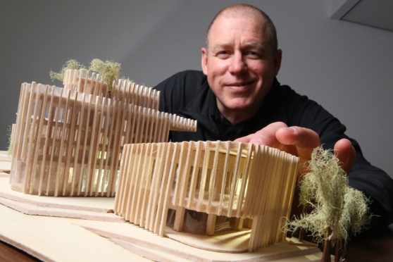 Dez Jones, one of the students, with the model he built of how the site could look.