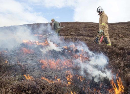 Head keeper Iain Hepburn and station officer Alex McKinley of the Scottish Fire Service carry out controlled burning on the Dunmaglass Estate