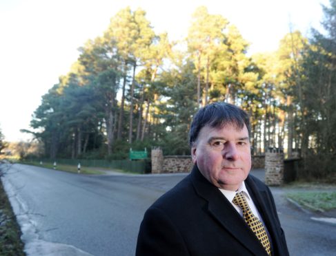 Highland Councillor Ken Gowans at the site of the proposed development at Treetop Riding Centre in Culloden Moor.