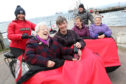 Ian Rankin joined Jean Young, Fiona Grist, Cromarty Care Project trustee Shirley Matheson, June Shepard and Ian Mitchell as two trishaws were delivered to Cromarty