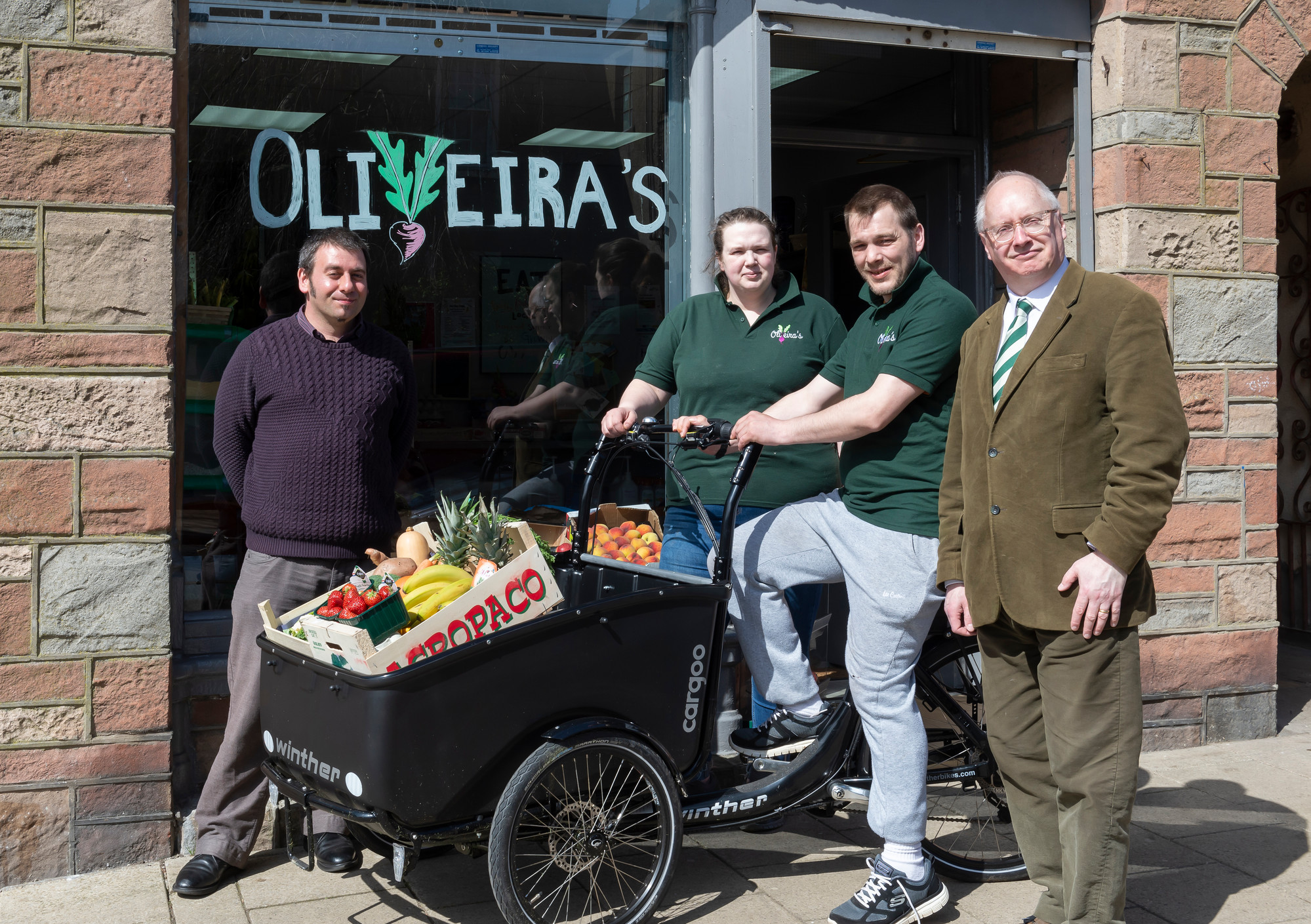 (l-r) Anthony Robertson strategic development officer for Aberdeenshire Council, Cat Henriques De Oliveira, Antero Henriques De Oliveira and Cllr Glenn Reynolds with the Electric cargo bike outside Oliveira’s greengrocer in Banff