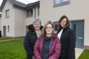 Communities Committee chairwoman Anne Stirling, Erroll Court resident Julie Killoh, and committee vice-chairwoman Cllr Iris Walker. The Turriff properties are existing affordable homes built by the council.