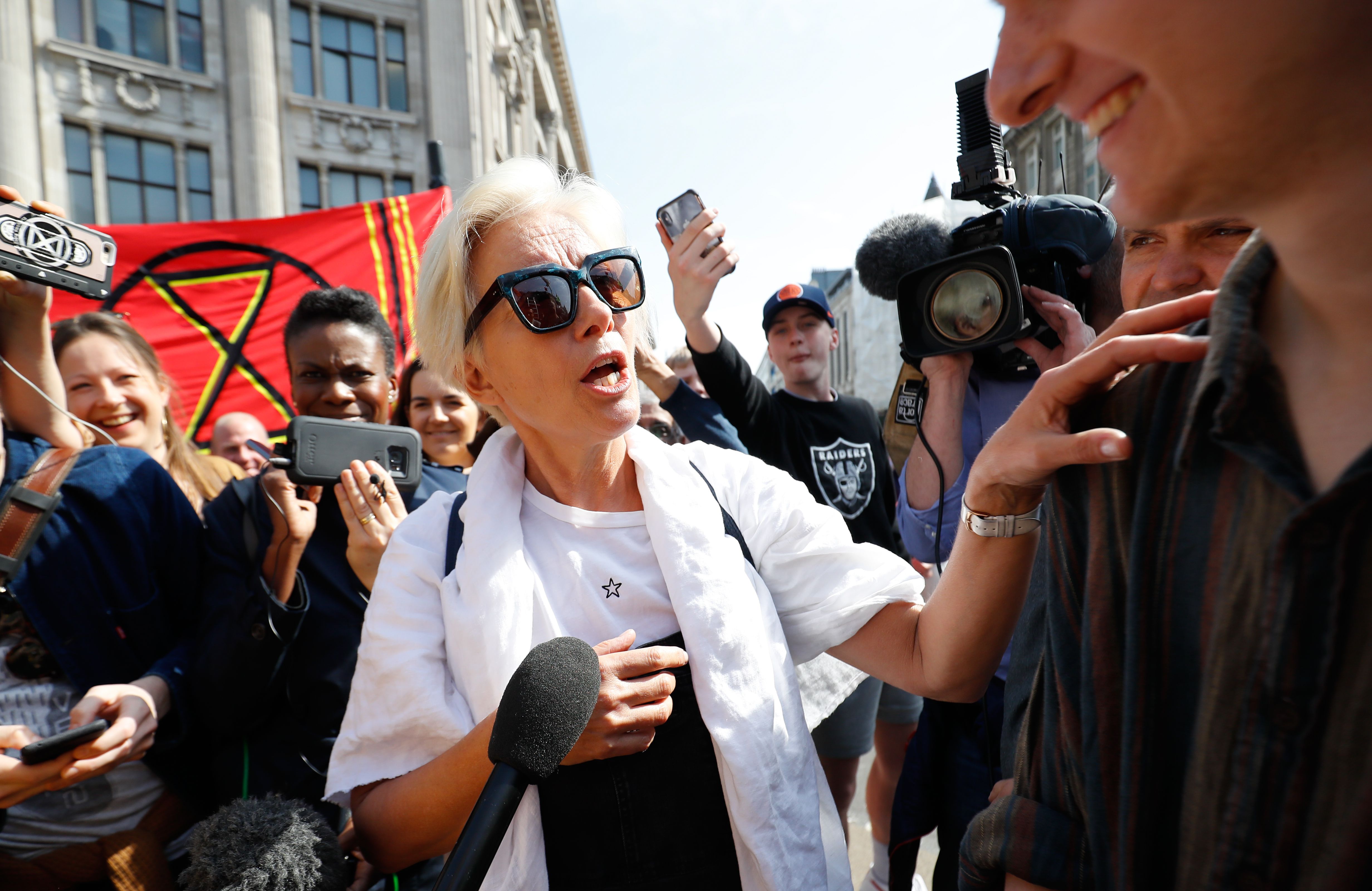 British actress Emma Thompson speaks to media as she joins climate change activists occupying the road junction at Oxford Circus in central London on April 19, 2019 during the fifth day of an environmental protest by the Extinction Rebellion group. - Undeterred by over 400 arrests, climate change activists continued their demonstration into a fifth day in London with a small protest at the country's main Heathrow Airport, along with the ongoing protest camps at other iconic locations around the British capital.  Demonstrators began blocking off a bridge and major central road junctions on April 15 at the start of a civil disobedience campaign calling for governments to declare an ecological emergency over climate change, to reduce greenhouse gas emissions to zero by 2025, halt biodiversity loss and be led by new "citizens' assemblies on climate and ecological justice". (Photo by Tolga AKMEN / AFP)        (Photo credit should read TOLGA AKMEN/AFP/Getty Images)