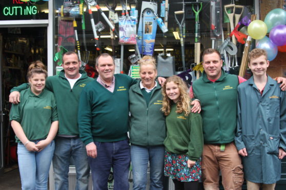Kevin Milkins and his family outside the shop prior to its official opening in April 2010.