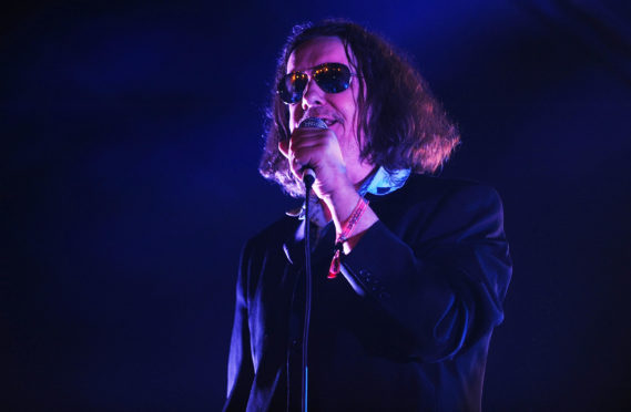 Jake Black perfoming with The Alabama 3 in Belladrum in 2013.