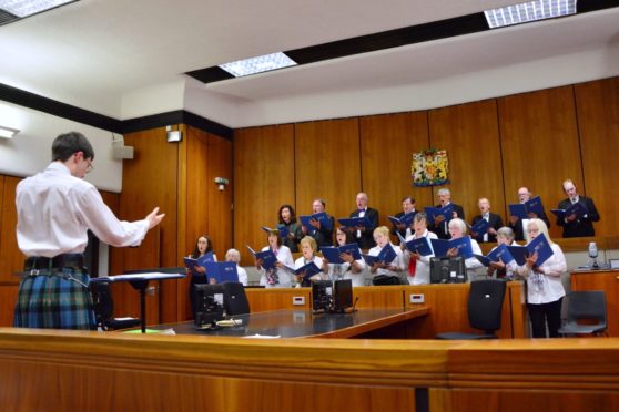 James Campbell directing the singers of Ugie Voices in Peterhead Sheriff Court