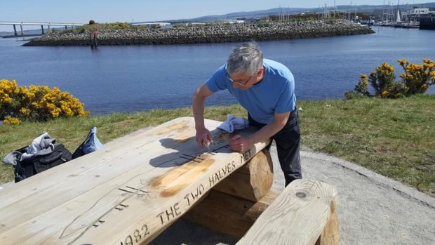 Andrew Zeglicki sanding down the damaged picnic bench at Carnac Point, South Kessock.