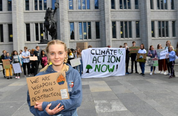 The Aberdeen Student Climate Strike on Friday. The students in Aberdeen are gathered in front of the Marischal College at 11am to show their support in the global movement against the climate change.    
Pictured - Isabella Maria Engberg in front of the protesters.    
Picture by Kami Thomson    24-05-19