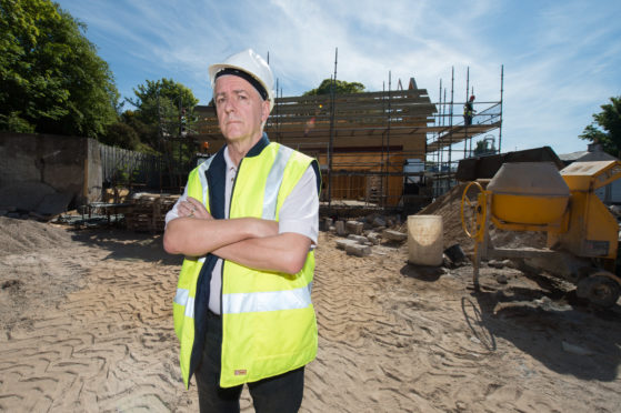 Picture by JASON HEDGES  

Picture shows Design Consultant Colin T. Keir at the construction site of the new Co-op on the high street in Lhanbryde.