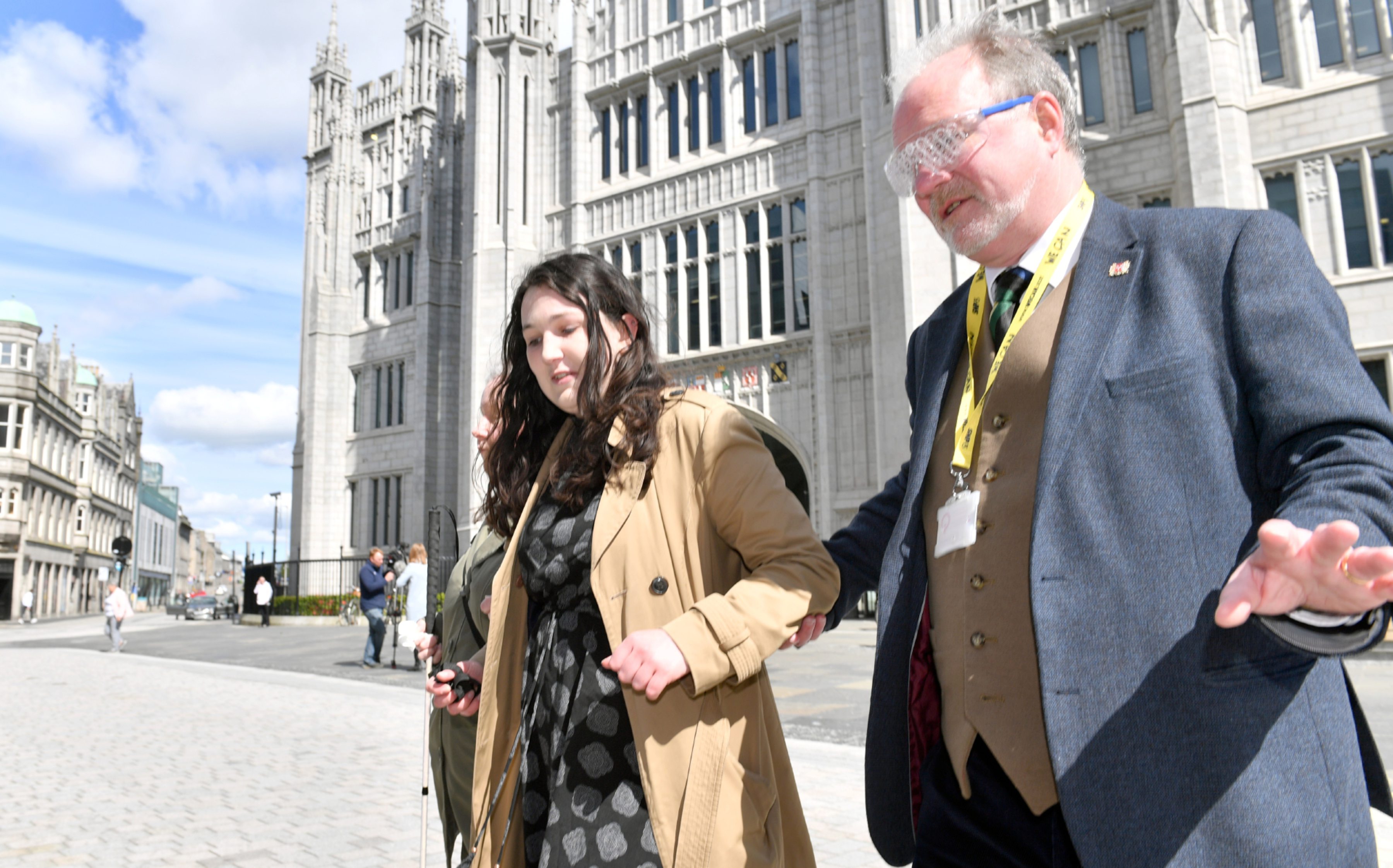 Amanda Burt and Cllr John Cooke are helped across the road by Guide Cate Vallis.    
Picture by Kami Thomson