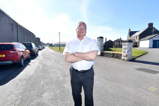 Councillor john cox outside the coastguard station at Battery Green, Banff where parking has been causing problems for emergency services.