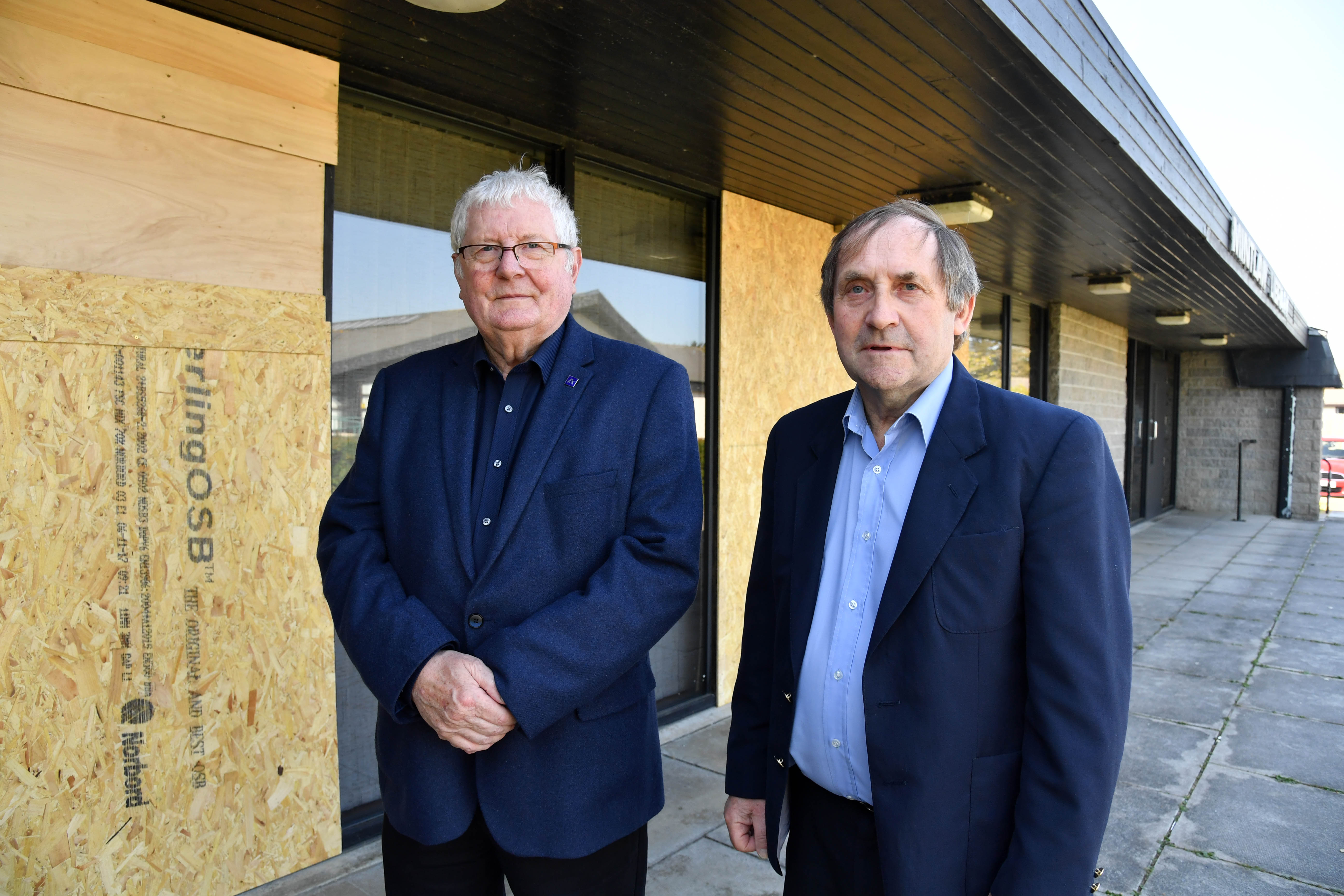 Councillors Norman Smith (l) and Jim Ingram at Mintlaw public library where vandals have smashed several full length windows.