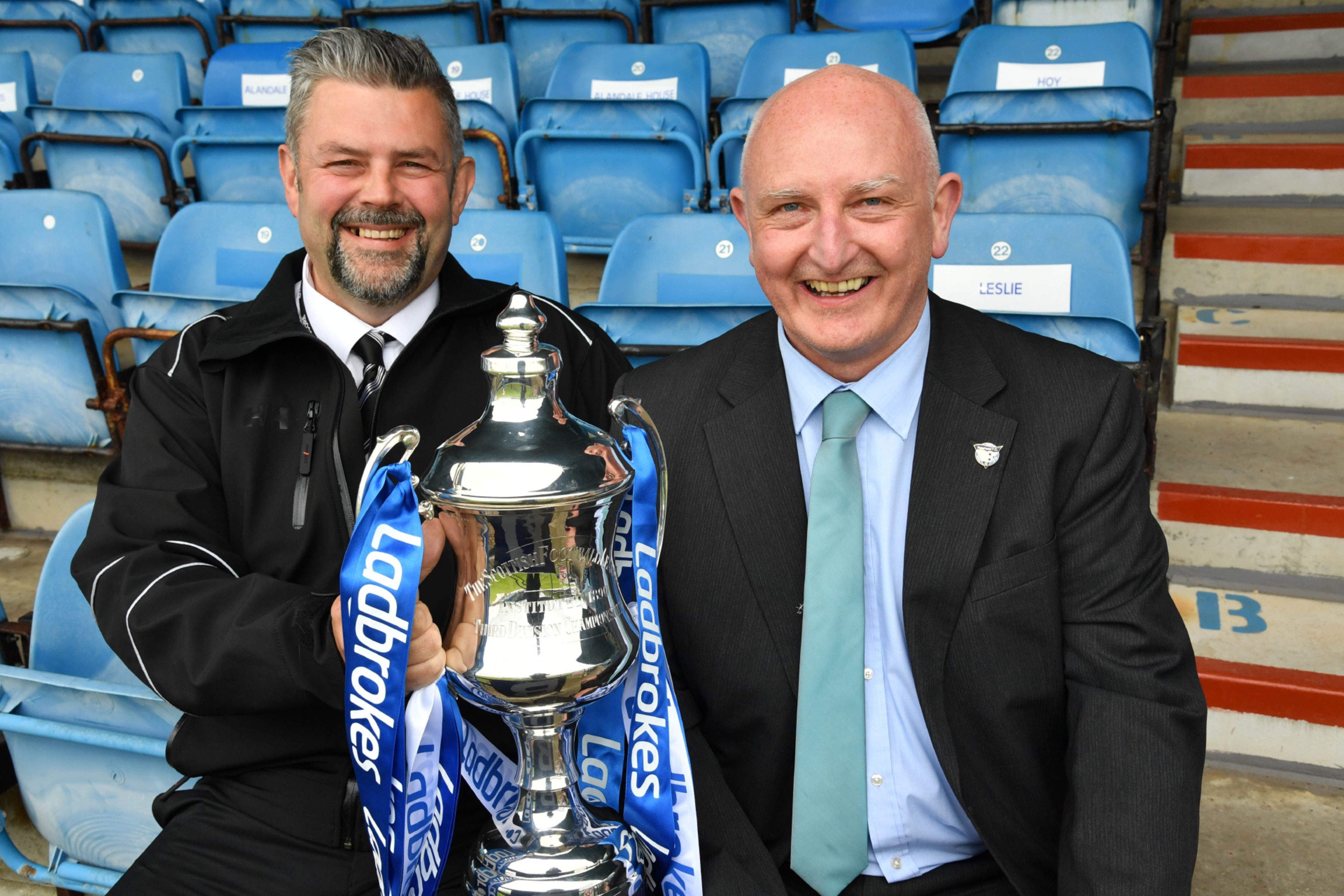 PETERHEAD FC CHIEF EXECUTIVE MARTIN JOHNSTON (R) AND CONRAD RITCHIE FROM SCORE WITH THE LEAGUE 2 TROPHY.