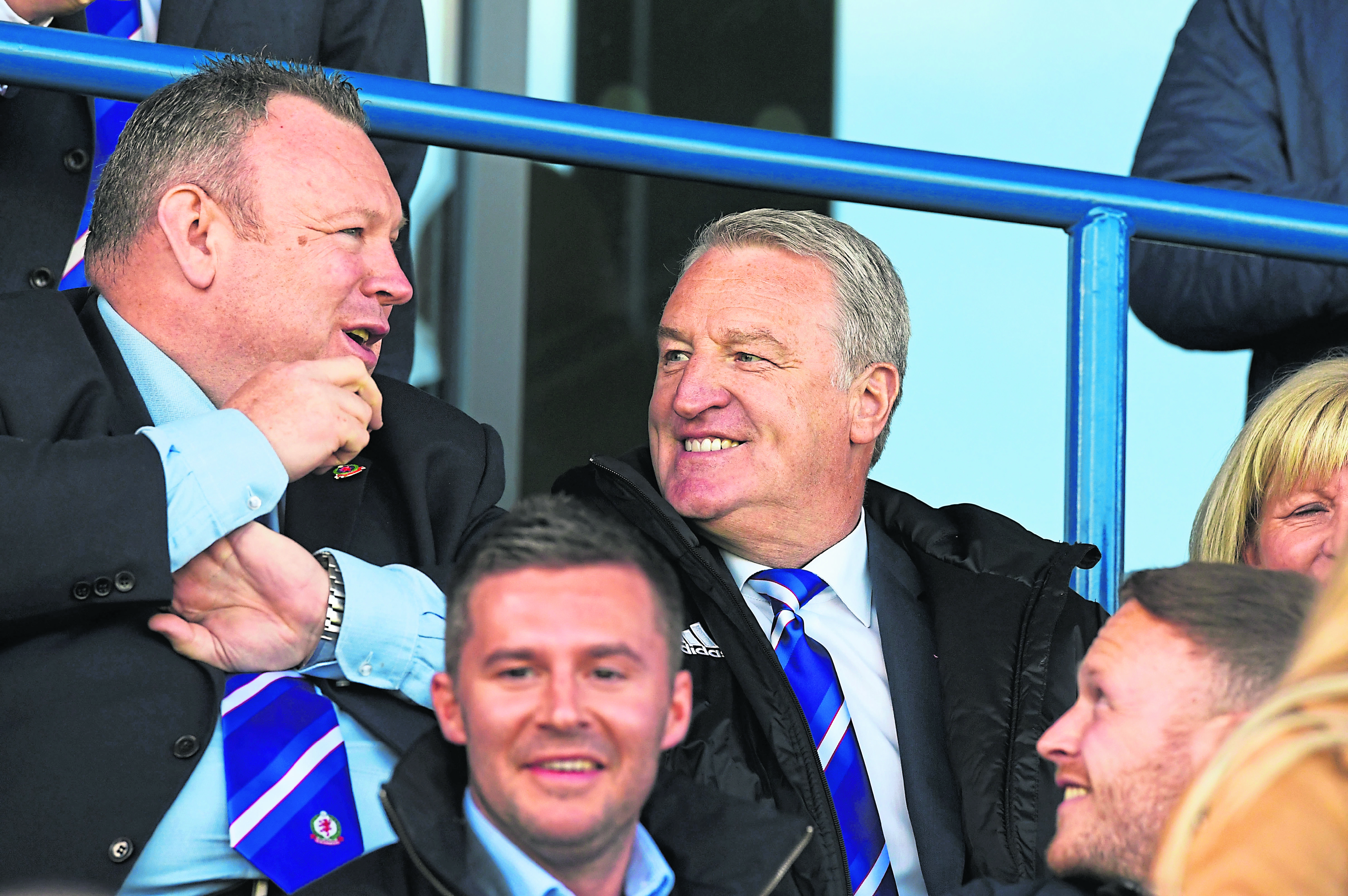 Cove Rangers manager John Sheran (R) takes in the game from the stands.
