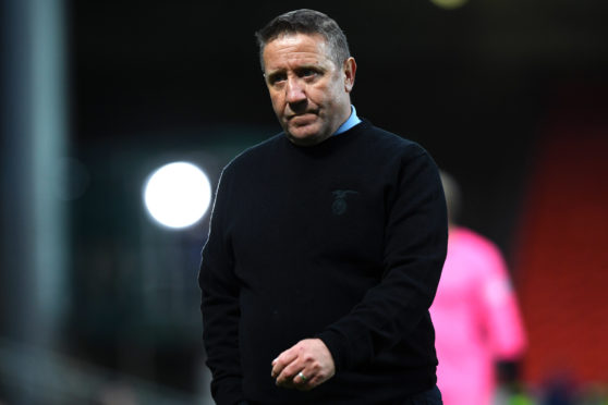 Inverness CT manager John Robertson looks dejected as his side lose 4-0 over two legs, missing out on promotion possibility.