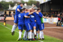 Cove players celebrate with Jordon Brown after his goal against Berwick.