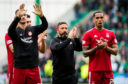 Aberdeen manager Derek McInnes applauds the club's supporters with his players on Sunday.