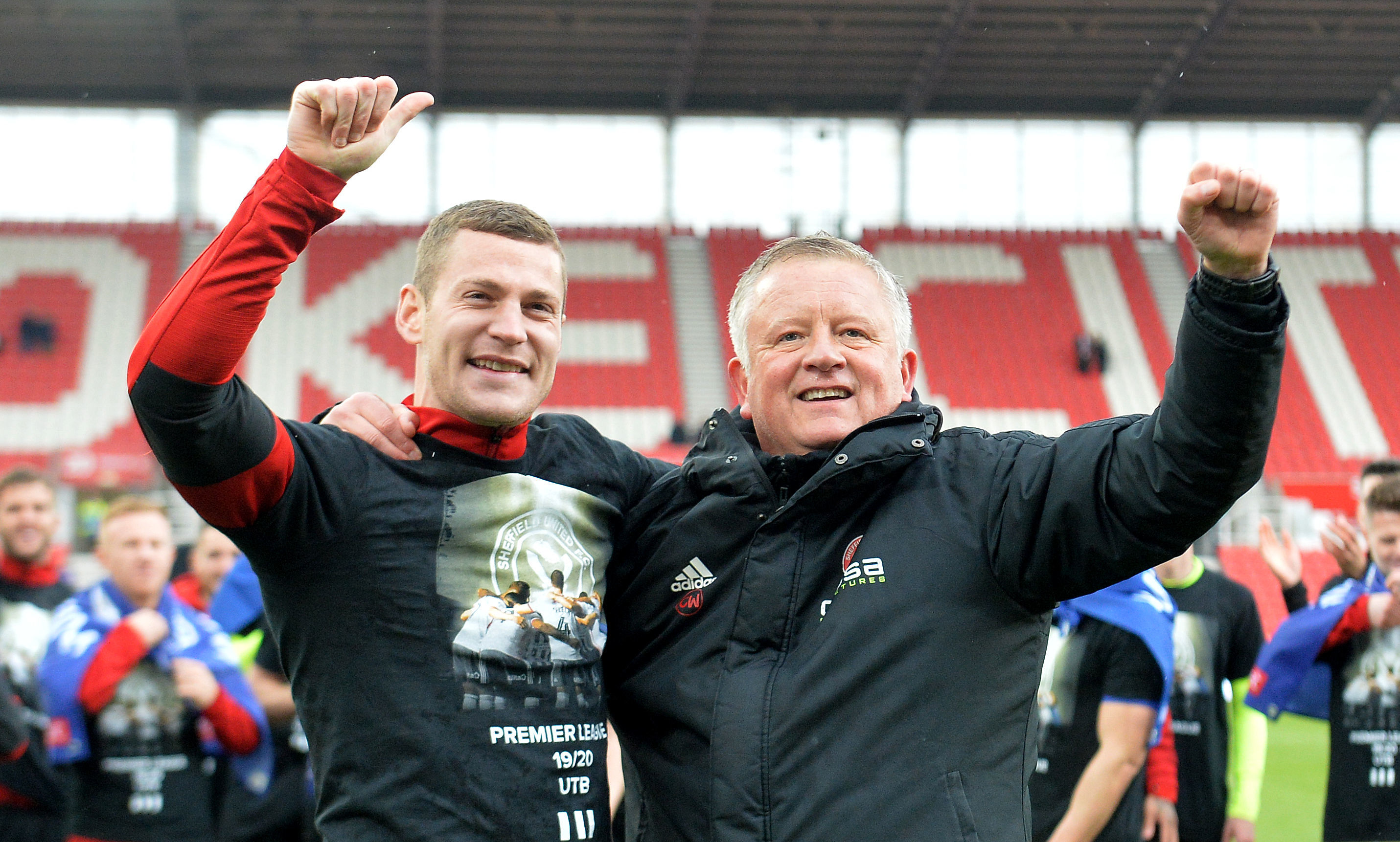 Sheffield United's Paul Coutts (left) and manager Chris Wilder celebrate promotion to the Premier League.