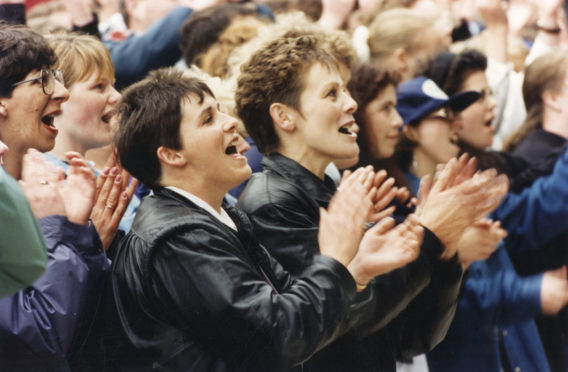 Singing in the rain... Fans join in as Runrig belt out one of their numbers.