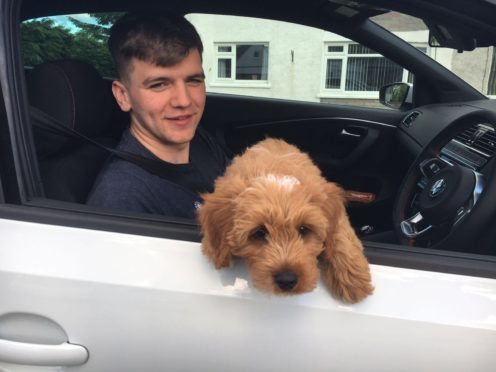 Alex Hutcheon inside his beloved Volkswagen Polo GTI.