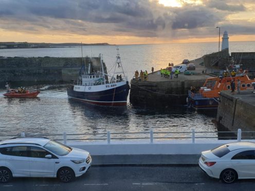 The lifeboat bringing the stricken trawler into Macduff Harbour. Picture taken by Kate Underdown