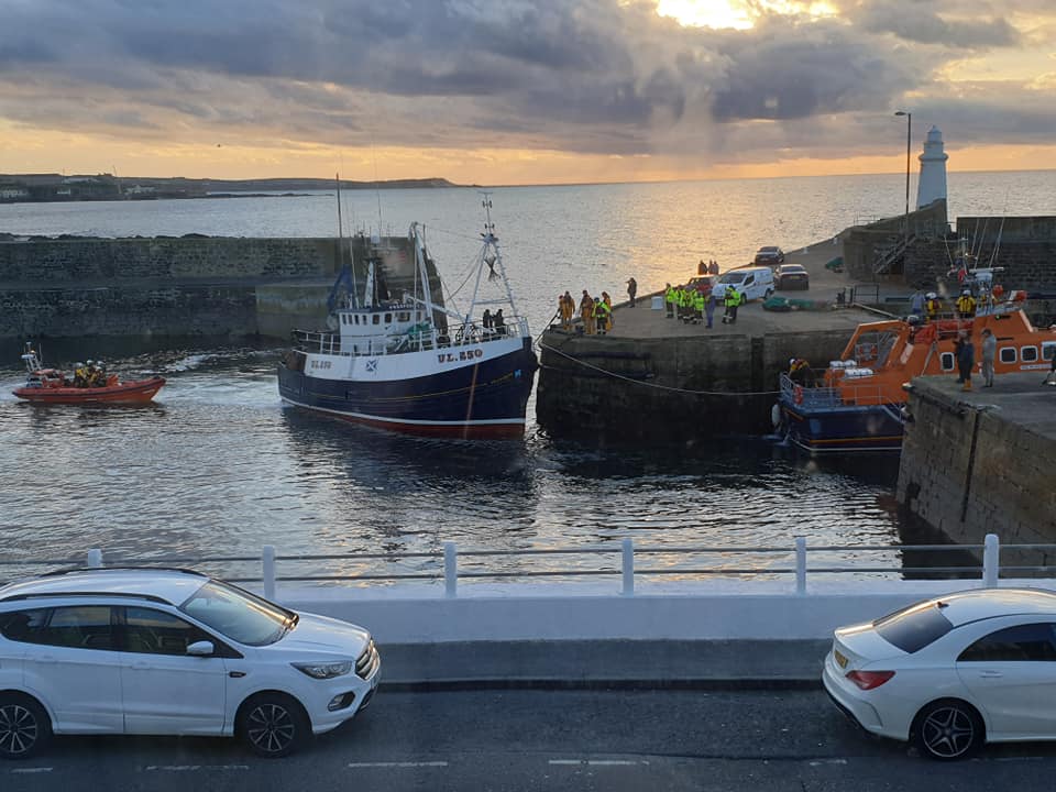 The lifeboat bringing the stricken trawler into Macduff Harbour. Picture taken by Kate Underdown