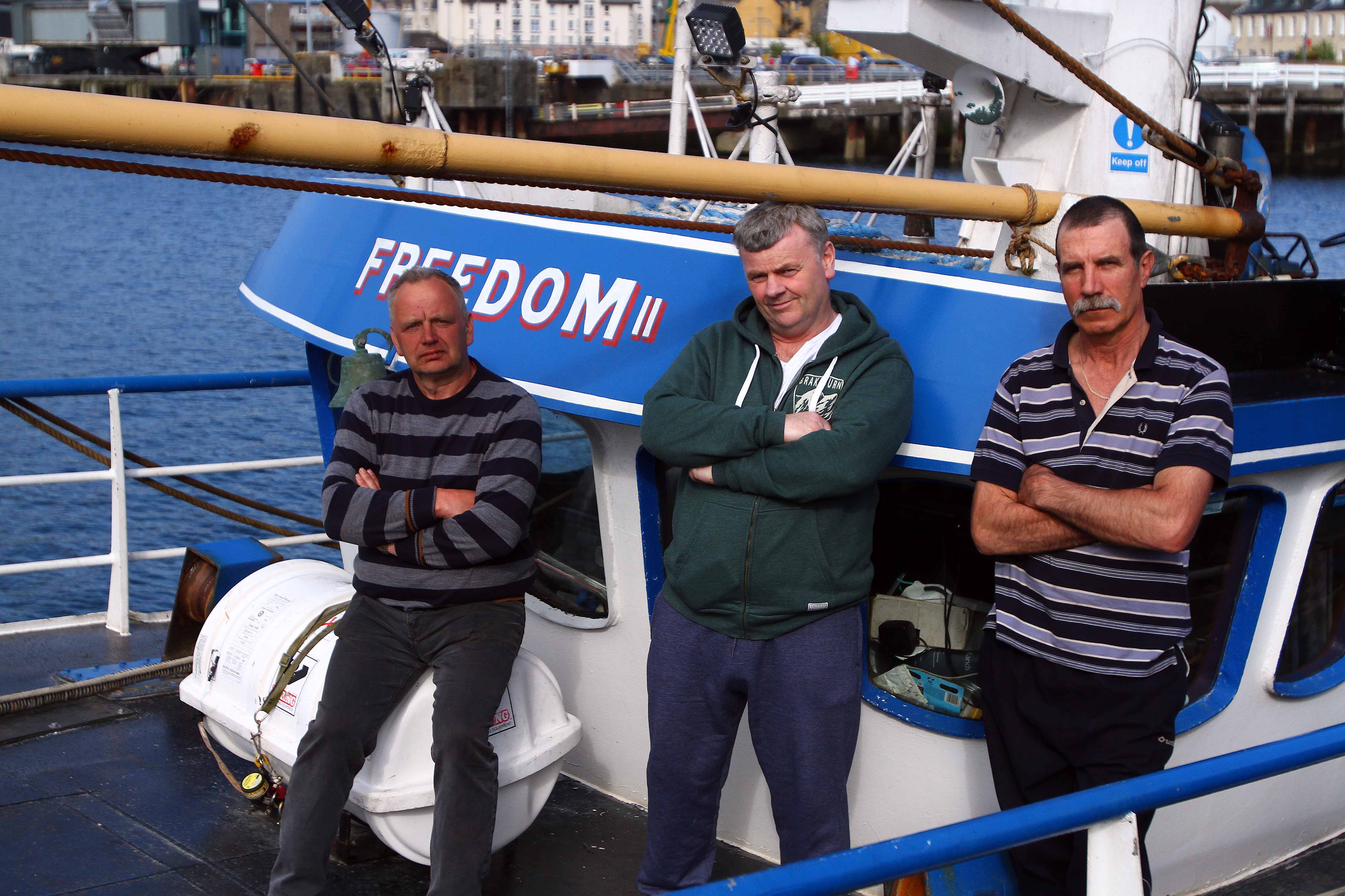 Angry skipper Jonathan MacAllister (centre) with latvian crewmen Guntis Hausmanis (right) and Janis Stals tied up aboard the Freedom losing money waiting for their crewman.