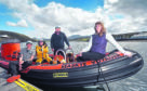 Seaskye's 11-metre vessel (pictured) will be upgraded to a 13- metre vessel, with HIE support. L-R: Jordan Young, Mark Coombe and Kenny MacKinnon of Seaskye Marine, with Eilidh Ross of HIE. Picture by Iain Smith/HIE.