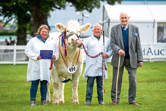 Tracy and Davie Nicoll and Major Walter with the supreme champion.