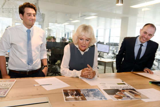 The Duchess of Rothesay (centre) looks at the next day's papers with Derry Aldritt and P&J editor Alan McCabe.