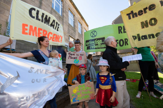Moray Council has declared a "climate change emergency". Pictured: Kate Mackay with Kai and Rachael Macintyre with Ossian.