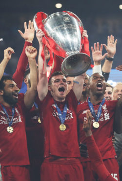 MADRID, SPAIN - JUNE 01: Andy Robertson of Liverpool  lifts the trophy during the UEFA Champions League Final between Tottenham Hotspur and Liverpool at Estadio Wanda Metropolitano on June 01, 2019 in Madrid, Spain. (Photo by Ian MacNicol/Getty Images)