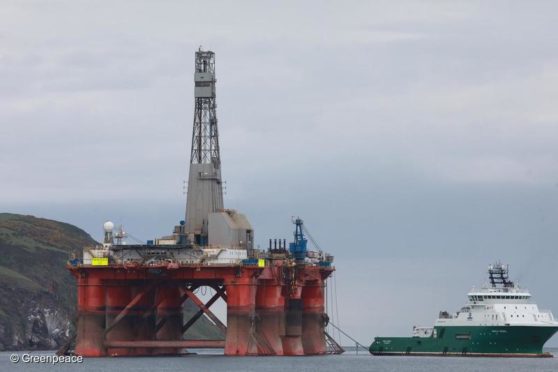 3 Greenpeace climbers on BP oil rig in Cromarty Firth, Scotland