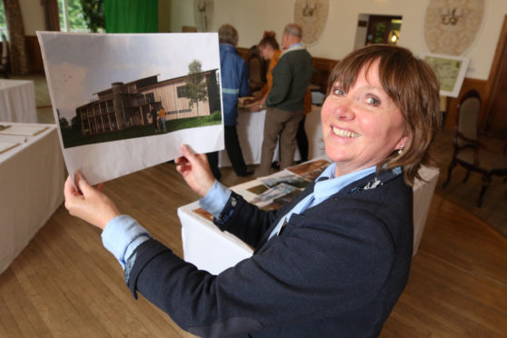 Highland Wildlife Park's head of operations Daska Mackintosh with an artist's impression of what a new visitors centre at the park would look like.
