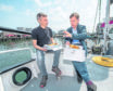Conservative party leadership candidate Jeremy Hunt (right) has some fish and chips with skipper James West on board of West's boat during his visit to Peterhead. Photo by Michal Wachucik/PA Wire