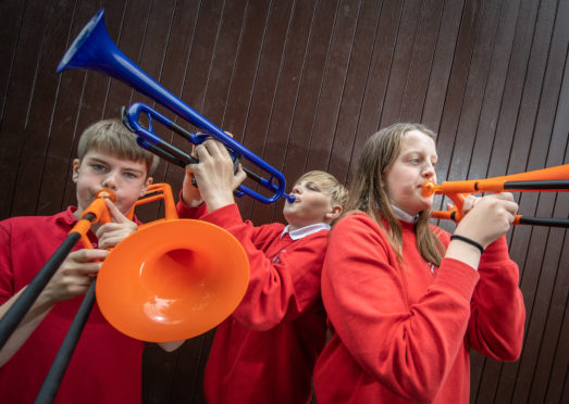 Zander Fleming, Kieran Powley and Callie Esson have all learned to play brass musical instruments on plastic equivalents.