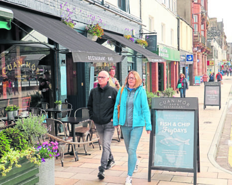 Pedestrians walking on George Street, Oban have to avoid business advertising signs. Picture by Kevin McGlynn
