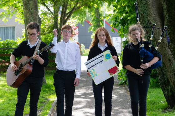 Picture by JASON HEDGES  

Students at rural Speyside High School take break from classes to hold climate change protest in the hope that natural environment where they live will be preserved for future generations.

Picture: Fraser MacDonald (Guitar) Alexander Bond (white shirt)  Freya Gordon (protest sign) and Rhea Fraser (Bagpipes)