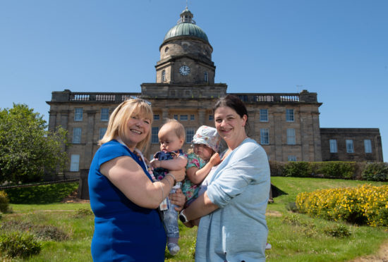 Pam Gowans, NHS Grampians executive lead for Dr Gray's, and mum Joanna Abbot with her children Erin and Zachary outside Dr Gray's.