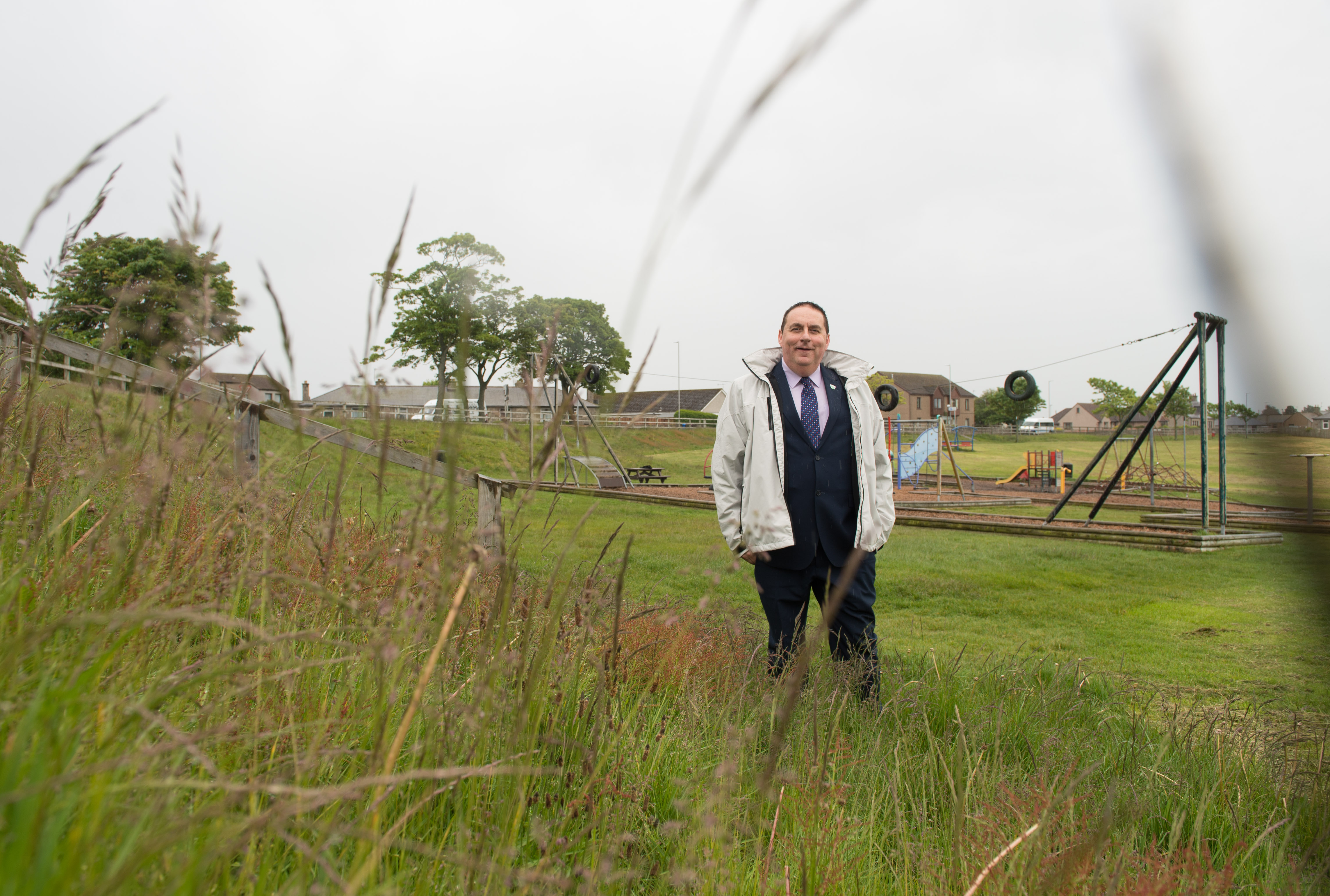 Councillor James Allen is pictured at Lossiemouth playing fields at the site of where the grass has now been cut.