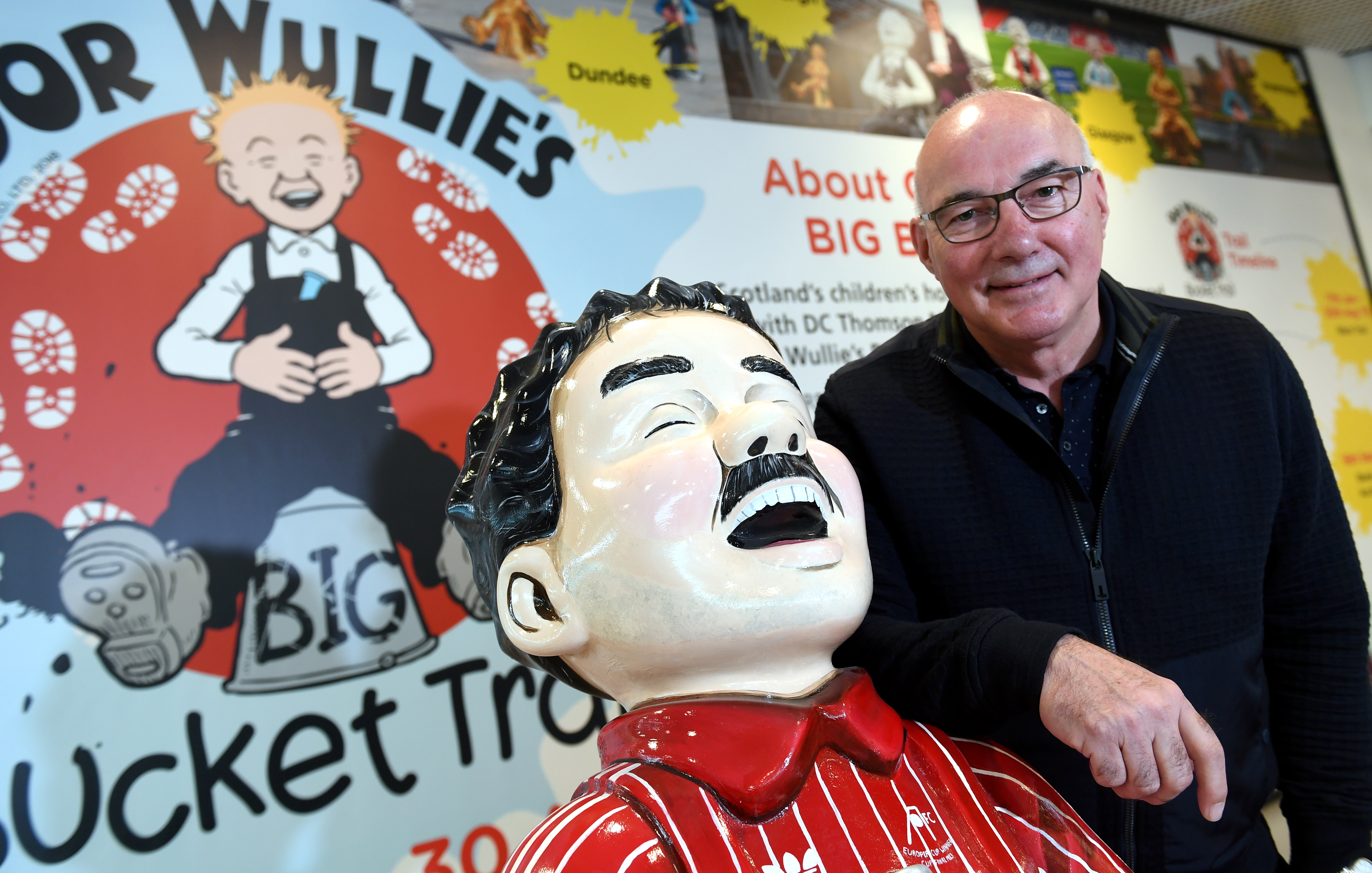 CR0010263
Former Dons captain Willie Miller visited the Oor Wullie Bucket Trail shop in the Bon Accord centre today (wednesday) to sign the sculpture by artist Sarah Mauchline that will be displayed and auctioned for the Archie Foundation.       
Pictured - Willie Miller with the Oor Wullie Miller statue.      
Picture by Kami Thomson    12-06-19